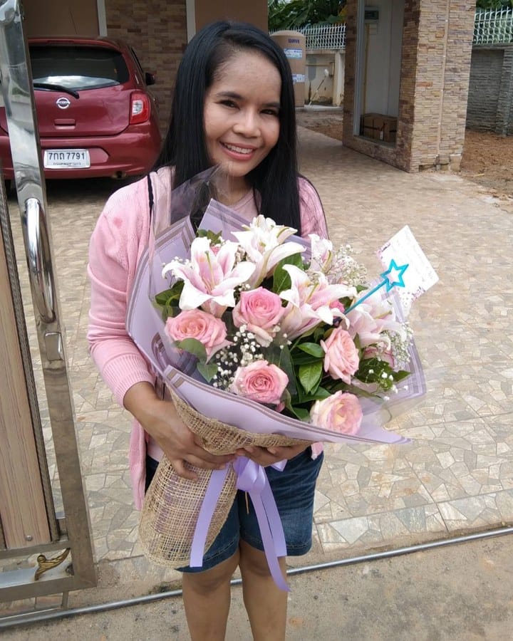 ลูกค้ากำลังรับช่อลิลลี่ กุหลาบ และยิปโซ สีชมพูและขาว (สินค้าอื่น)